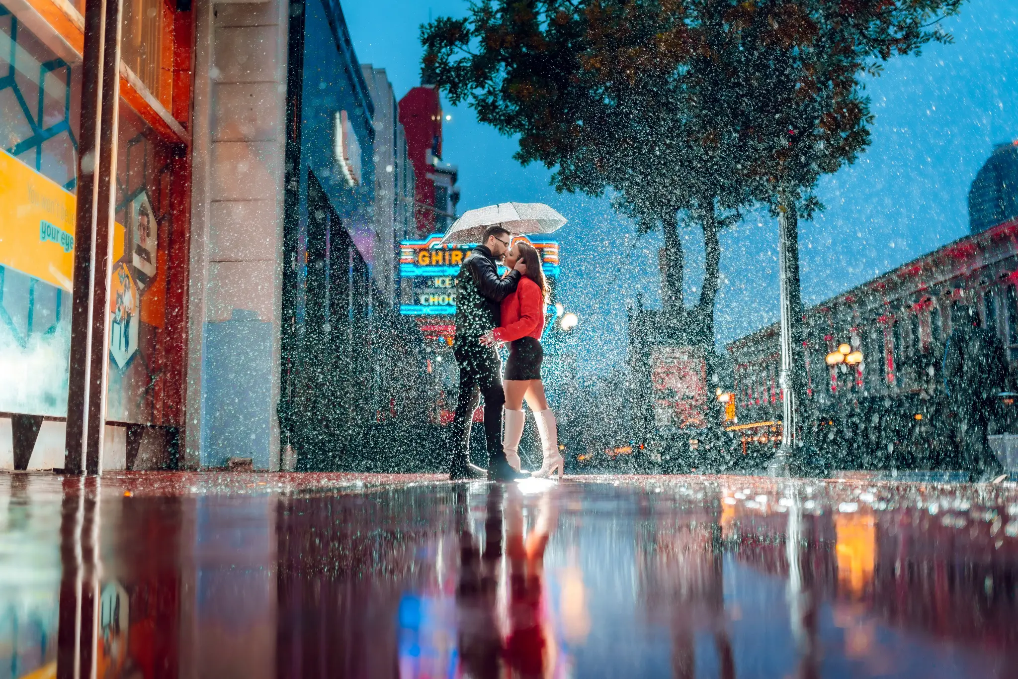 session photography by Sonny Abdul — Wedding Story 09 couple embracing in the rain beneath a white umbrella